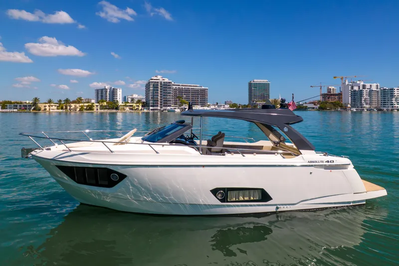 Slide: The Image of 2017 Absolute 40 STL yacht on calm water with city skyline background. - 70
