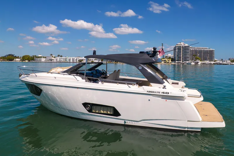 Slide: The Image of 2017 Absolute 40 STL yacht on calm water with cityscape background. - 71