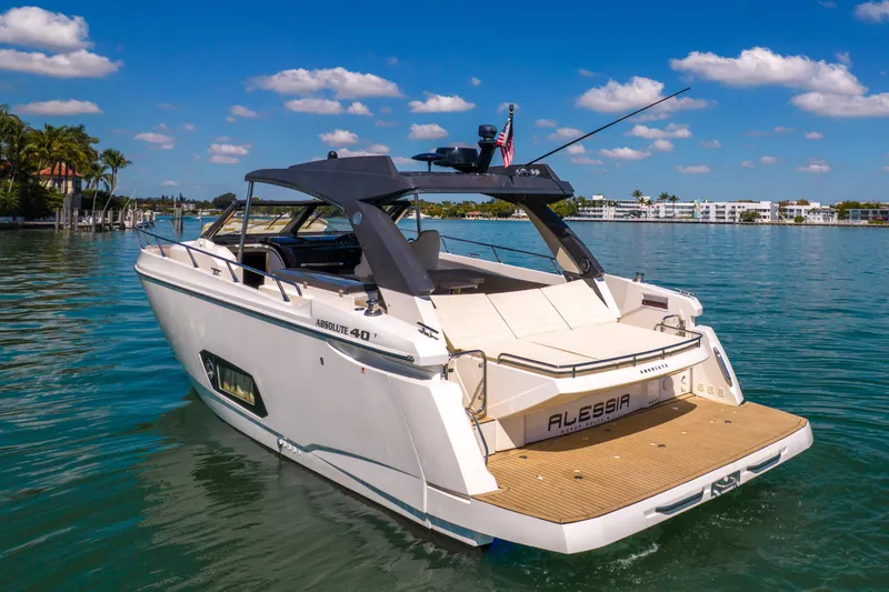 Slide: The Image of Luxury Absolute 40 STL yacht from 2017 on serene water, clear sky backdrop. - 72