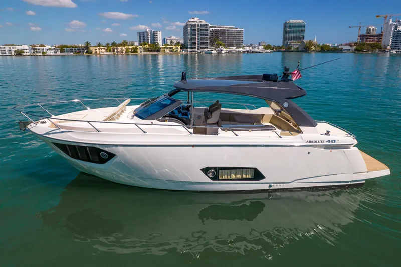 Slide: The Image of 2017 Absolute 40 STL yacht on calm water with city skyline backdrop. - 73
