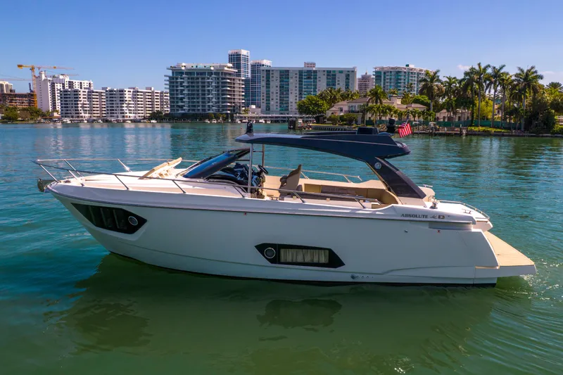 Slide: The Image of 2017 Absolute 40 STL yacht on calm water with cityscape background. - 75