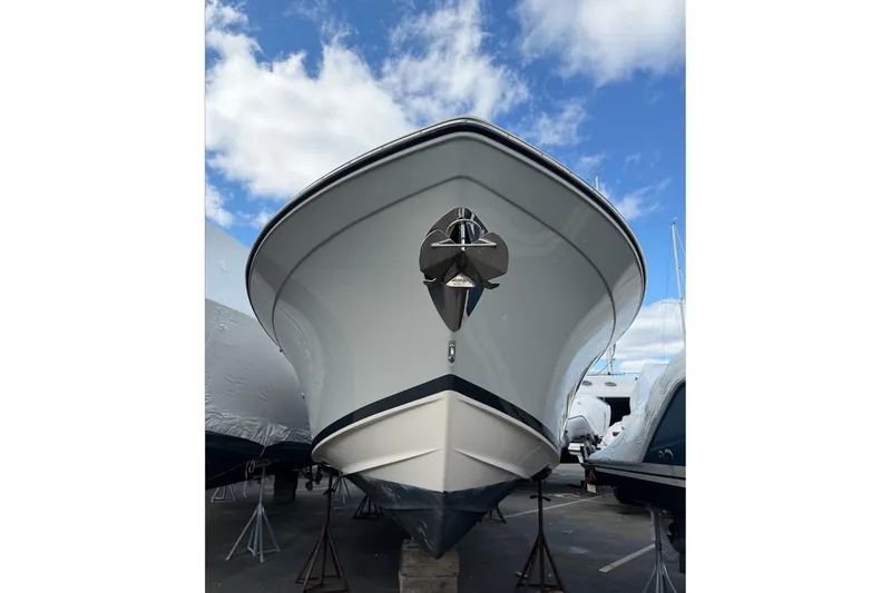Slide: The Image of 2020 Grady-White Freedom 285 boat on stands under a blue sky. - 2