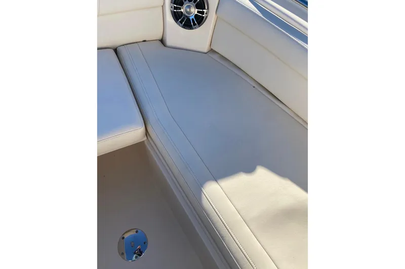Slide: The Image of 2020 Grady-White Freedom 285 boat interior with white seating and speaker detail. - 9