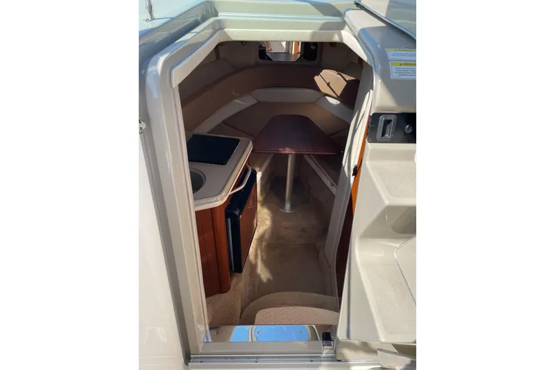 Slide: The Image of Interior view of 2011 Sea Ray 240 Sundancer cabin with kitchenette and seating area. - 17