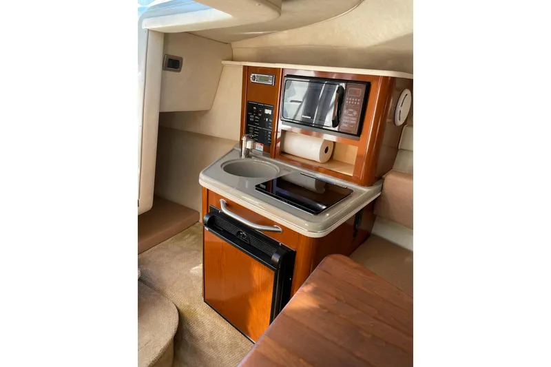 Slide: The Image of Compact galley in 2011 Sea Ray 240 Sundancer with microwave, sink, and mini-fridge. - 19