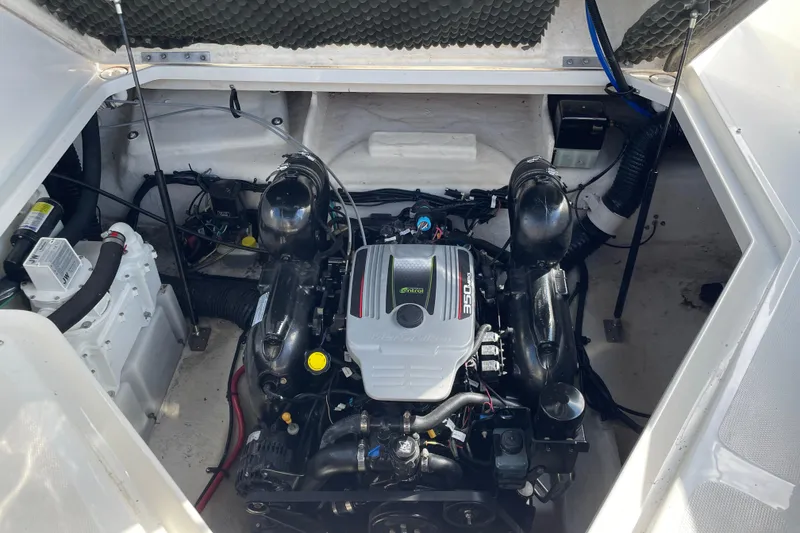 Slide: The Image of Engine compartment of a 2011 Sea Ray 240 Sundancer boat, showcasing the engine and components. - 24