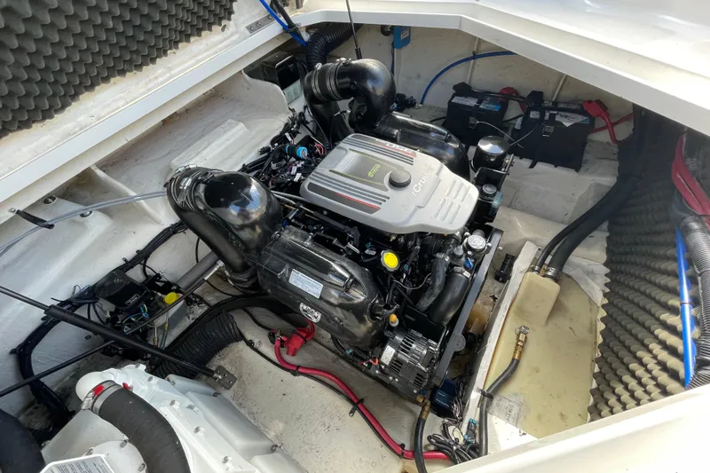 Slide: The Image of Engine compartment of a 2011 Sea Ray 240 Sundancer boat, showcasing the MerCruiser engine. - 25