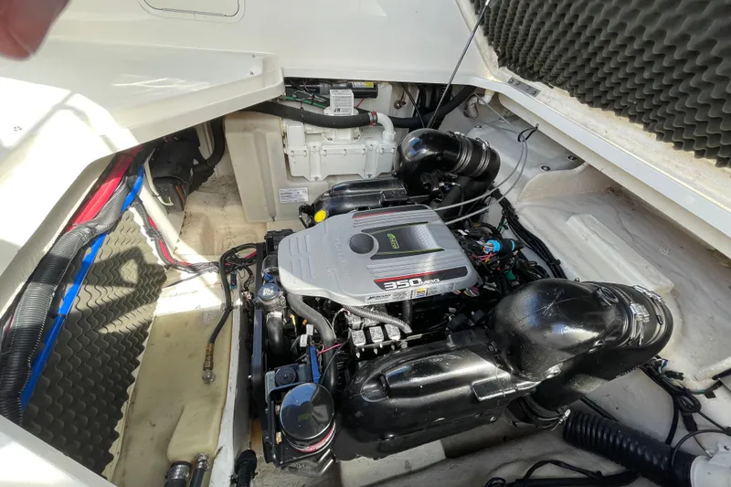 Slide: The Image of Engine compartment of a 2011 Sea Ray 240 Sundancer boat, featuring a 350 MAG engine. - 26