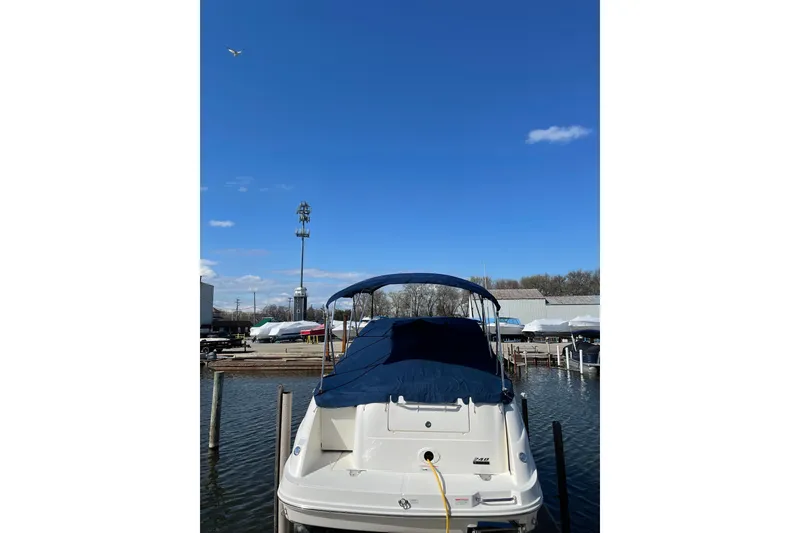 Slide: The Image of 2011 Sea Ray 240 Sundancer docked at marina under clear blue sky. - 7