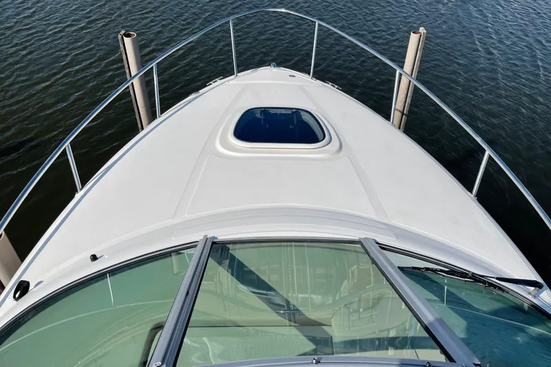 Slide: The Image of 2011 Sea Ray 240 Sundancer boat deck view on water. - 8