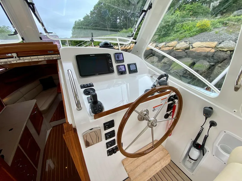 Slide: The Image of 2013 MJM 36z Downeast boat helm with steering wheel and navigation controls. - 12