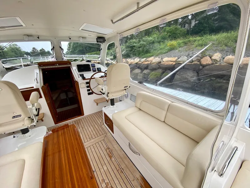 Slide: The Image of 2013 MJM 36z Downeast boat interior with seating, helm, and wooden flooring. - 16