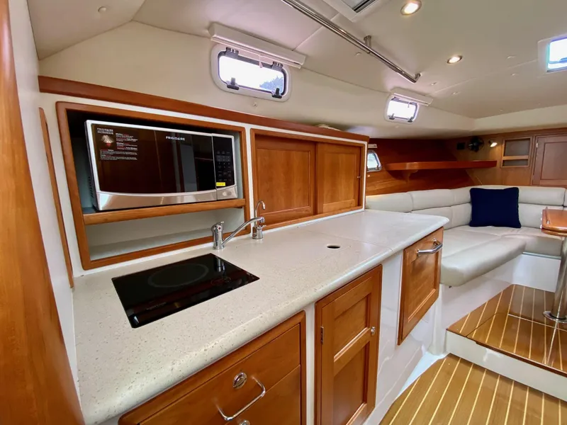 Slide: The Image of 2013 MJM 36z Downeast yacht interior with modern kitchen and seating area. - 21