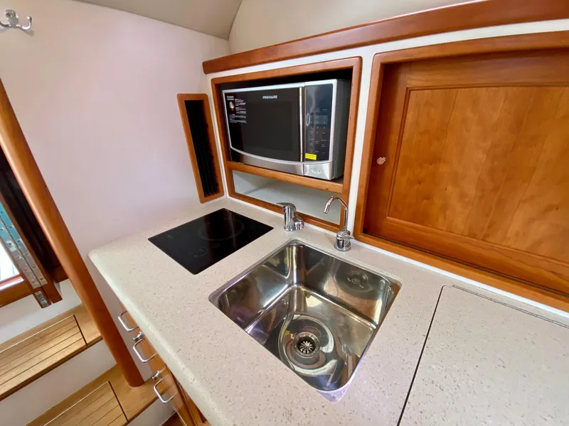 Slide: The Image of Compact kitchen area in 2013 MJM 36z Downeast boat with sink, stove, and microwave. - 23