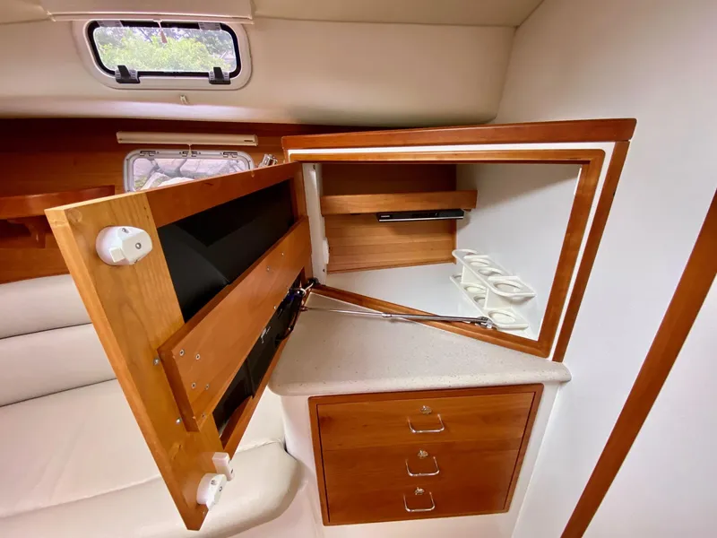 Slide: The Image of 2013 MJM 36z Downeast yacht interior with open wooden cabinet and drawers. - 25