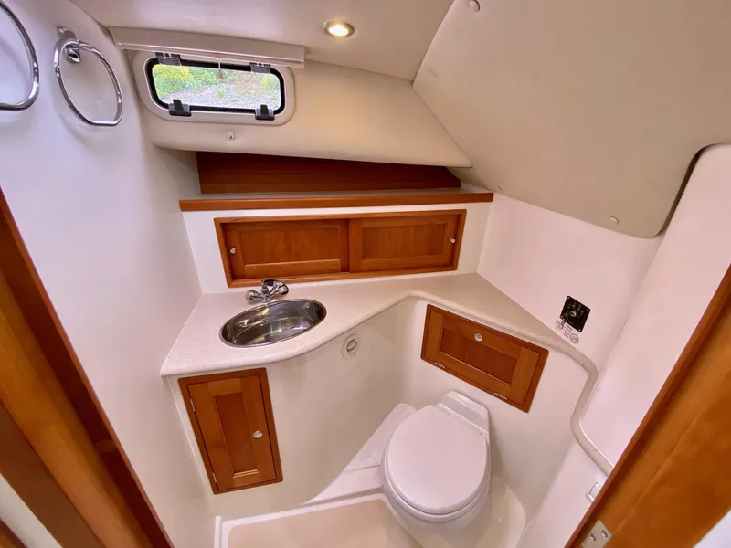 Slide: The Image of 2013 MJM 36z Downeast boat bathroom with wooden cabinets and compact design. - 27