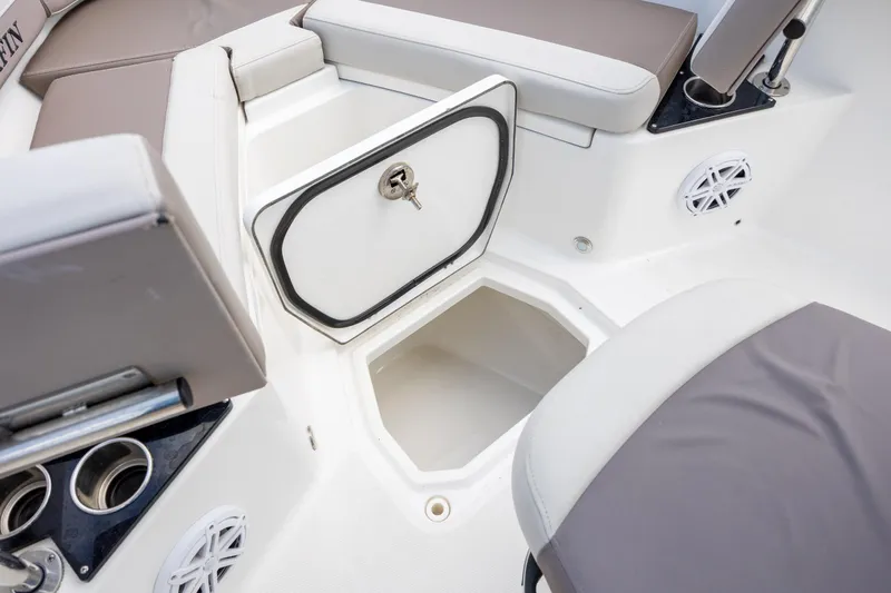 Slide: The Image of 2019 Blackfin 212 CC boat interior with open storage compartment and seating. - 14
