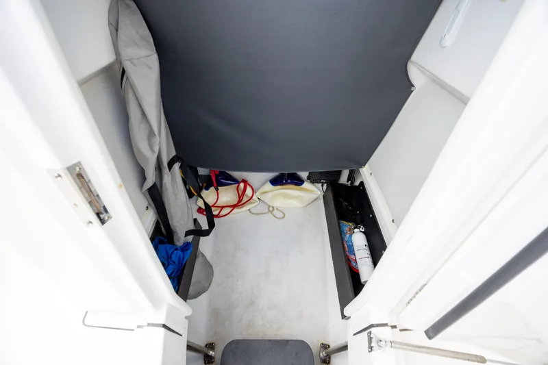 Slide: The Image of Interior storage area of a 2019 Blackfin 212 CC boat with safety equipment. - 17