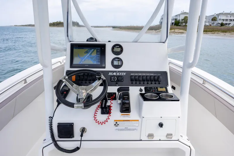 Slide: The Image of 2019 Blackfin 212 CC boat console with steering wheel, navigation display, and controls. - 20
