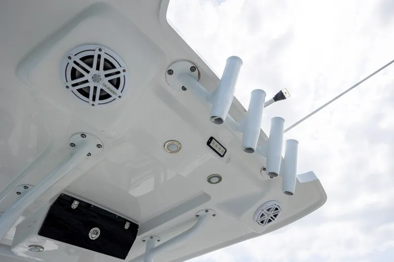 Slide: The Image of 2019 Blackfin 212 CC boat ceiling with speakers and rod holders. - 21