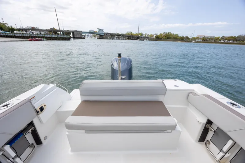 Slide: The Image of 2019 Blackfin 212 CC boat interior with seating, overlooking calm waters and distant shoreline. - 27