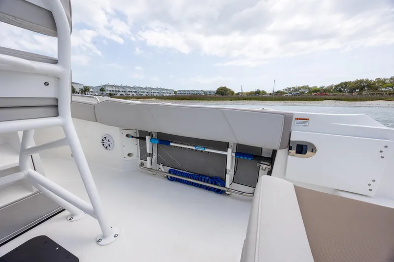 Slide: The Image of 2019 Blackfin 212 CC boat interior with seating and storage, near waterfront. - 29