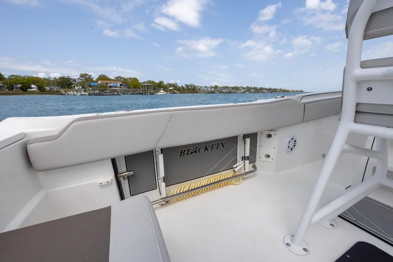 Slide: The Image of 2019 Blackfin 212 CC boat interior with coastal view and clear sky. - 30
