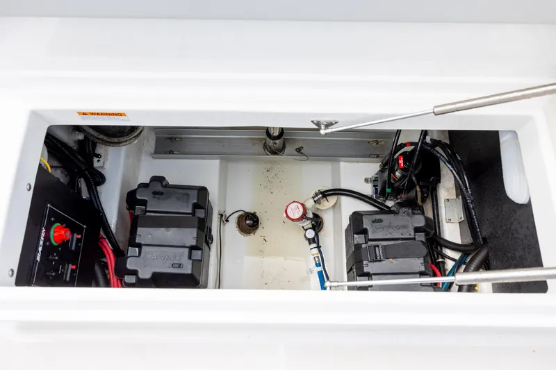 Slide: The Image of 2019 Blackfin 212 CC boat battery compartment with wiring and components. - 31