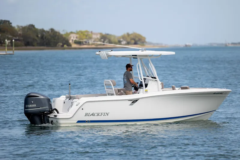 Slide: The Image of 2019 Blackfin 212 CC boat cruising on calm waters with Yamaha engine. - 4