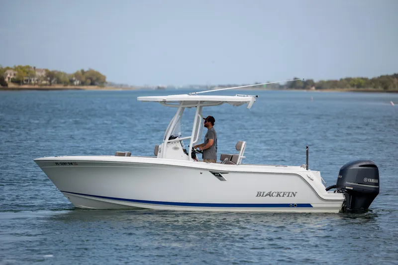 Slide: The Image of 2019 Blackfin 212 CC boat cruising on a calm lake with a Yamaha engine. - 8