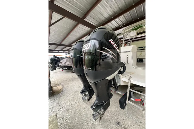 Slide: The Image of 1998 Pro-Line 2950 Walkaround with twin Mercury 250 outboard engines under a metal canopy. - 4