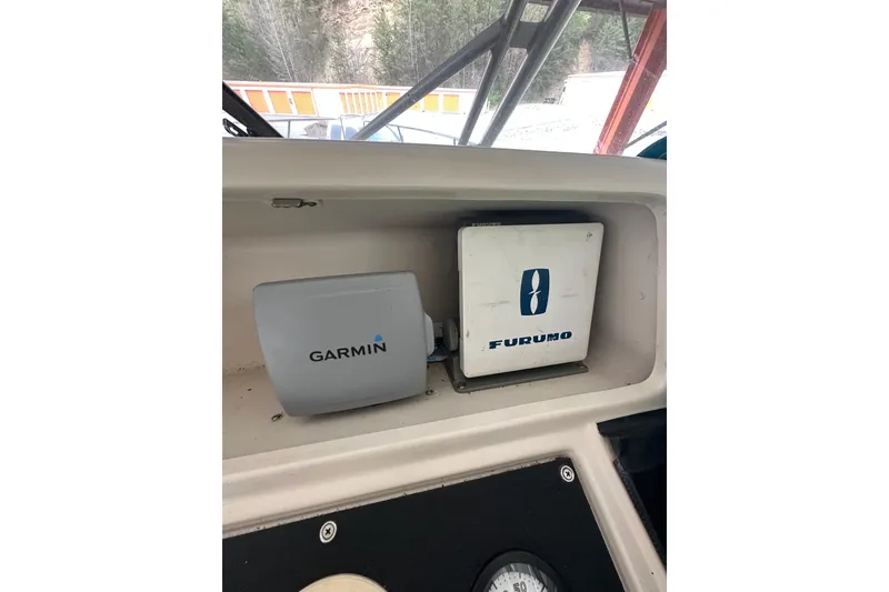 Slide: The Image of 1998 Pro-Line 2950 Walkaround boat dashboard with Garmin and Furuno navigation equipment. - 5