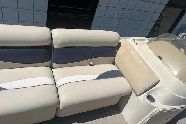 Slide: The Image of 2015 Godfrey Sweetwater 2286 C boat interior with beige and navy seating. - 11