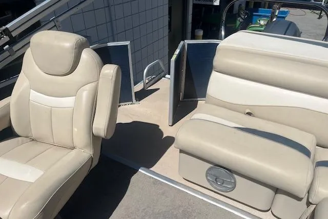Slide: The Image of 2015 Godfrey Sweetwater 2286 C boat interior with beige seating and open door. - 15