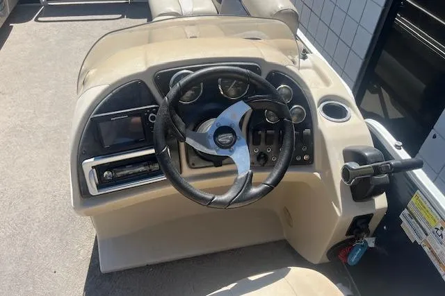 Slide: The Image of 2015 Godfrey Sweetwater 2286 C boat dashboard with steering wheel and control panel. - 17