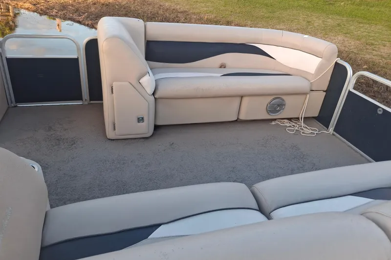 Slide: The Image of 2015 Godfrey Sweetwater 2286 C pontoon boat interior with beige seating and carpeted floor. - 4