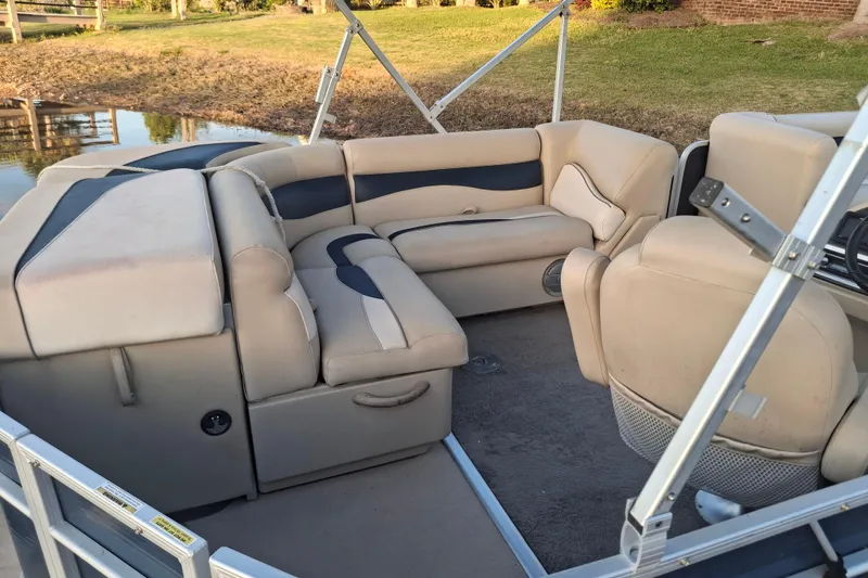 Slide: The Image of 2015 Godfrey Sweetwater 2286 C pontoon boat interior with beige seating. - 5