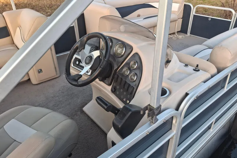 Slide: The Image of 2015 Godfrey Sweetwater 2286 C pontoon boat interior with steering console and seating. - 6