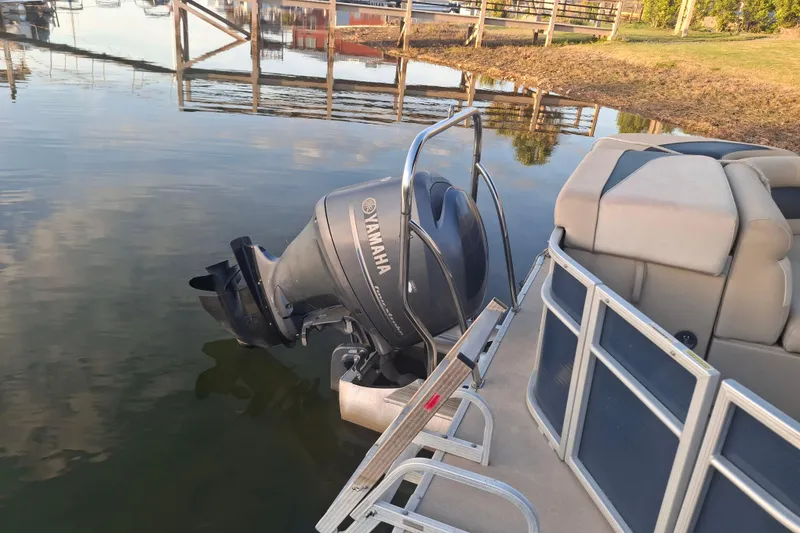 Slide: The Image of 2015 Godfrey Sweetwater 2286 C pontoon boat with Yamaha outboard motor on calm water. - 7