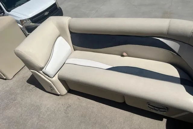 Slide: The Image of 2015 Godfrey Sweetwater 2286 C boat seating, beige and navy upholstery, outdoor setting. - 9