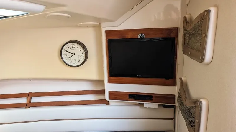 Slide: The Image of Interior of 2006 Grady-White Marlin 300 with wall-mounted TV and clock. - 12