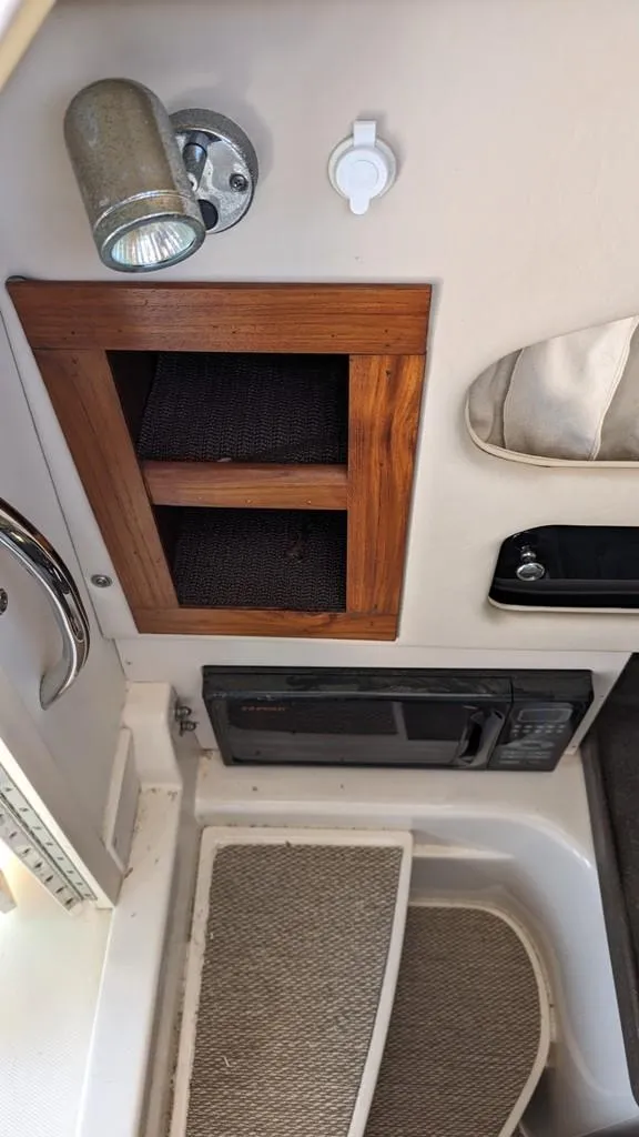 Slide: The Image of 2006 Grady-White Marlin 300 interior cabin storage and lighting. - 17
