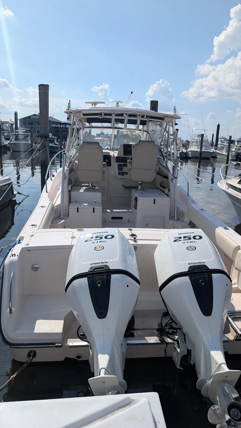 Slide: The Image of 2006 Grady-White Marlin 300 boat with twin 250 horsepower engines docked at marina. - 2