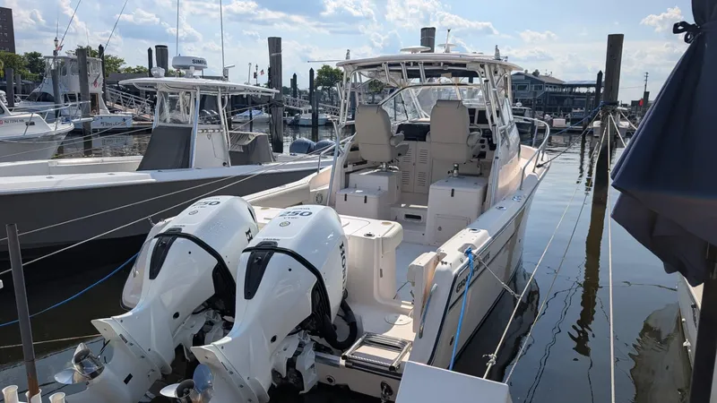 Slide: The Image of 2006 Grady-White Marlin 300 boat docked with twin Honda outboard engines. - 3