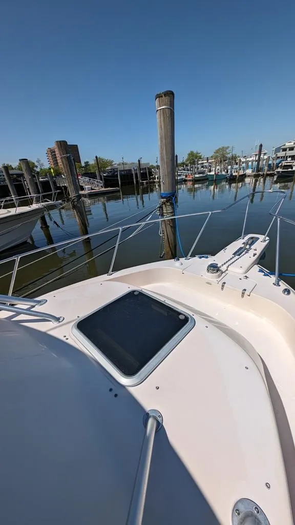 Slide: The Image of 2006 Grady-White Marlin 300 docked at a marina on a sunny day. - 5