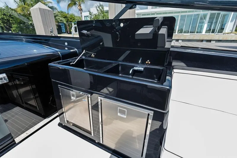 Slide: The Image of Luxurious 2021 VanDutch 40.2 yacht kitchenette with sleek black finish and modern amenities. - 13