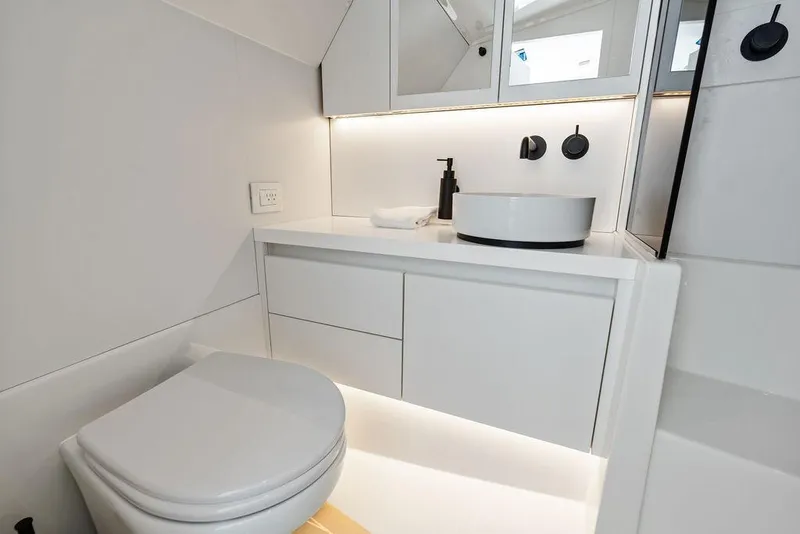 Slide: The Image of Modern bathroom interior on 2021 VanDutch 40.2 yacht, featuring sleek white design and vessel sink. - 21