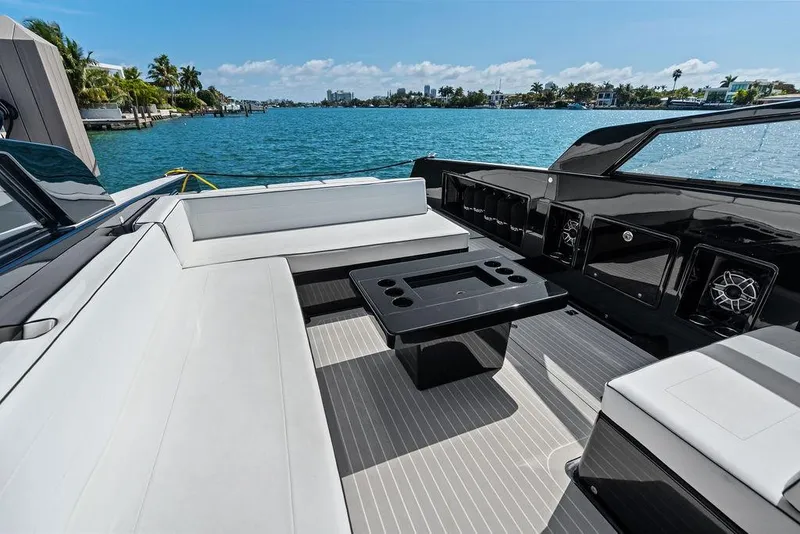 Slide: The Image of Luxurious 2021 VanDutch 40.2 yacht interior with sleek seating and table, overlooking serene waters. - 8