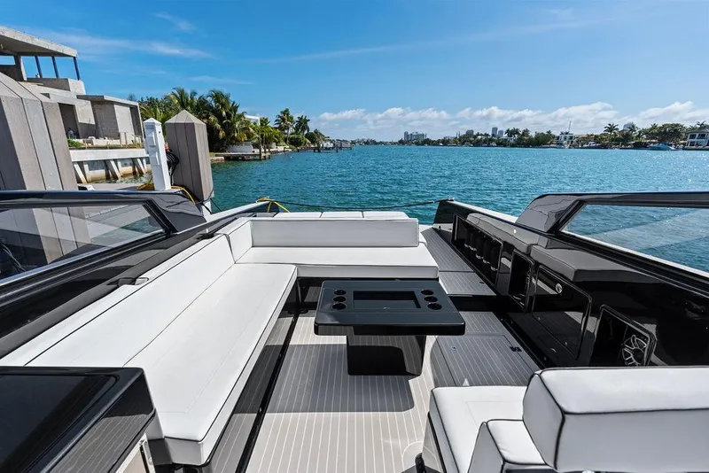 Slide: The Image of Luxurious 2021 VanDutch 40.2 yacht with sleek seating, docked by scenic waterfront. - 9