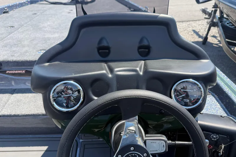 Slide: The Image of Dashboard of a 2026 Phoenix 721 ZXL boat with gauges and steering wheel. - 15